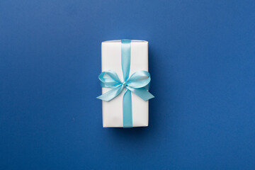 White gift box on color background, top view