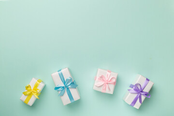 Colorful gift boxes on color background, top view