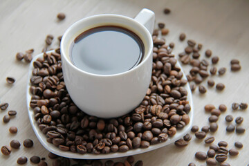Coffee cup with coffee beans close up