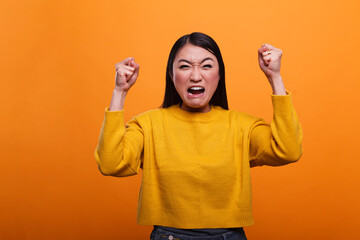 Mad furious asian woman angered and annoyed by loud music heard from neighbors. Upset frustrated...
