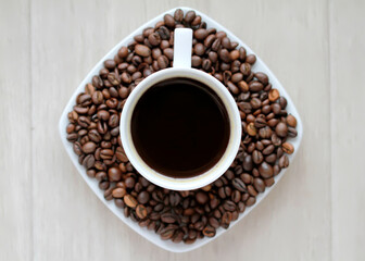 Coffee cup with coffee beans close up