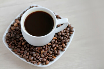 Coffee cup with coffee beans close up