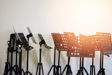 music Note stands on floor near white wall