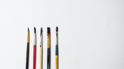 Paper of art work with part of  plate and color brushes