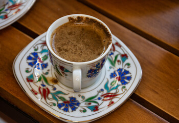 A cup of a turkish coffee on wooden table, traditional, Ramadan beverage