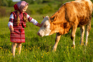 little girl grazing cows on the lawn