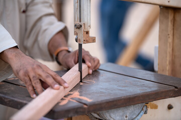 Worker Hands Details Of Wood Cutter Machine With A Circular Saw And Wooden Board