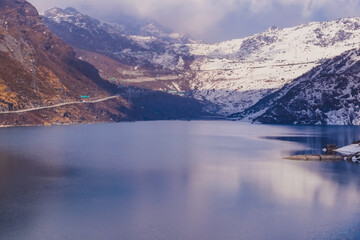 lake in mountains with snow and cloud.
