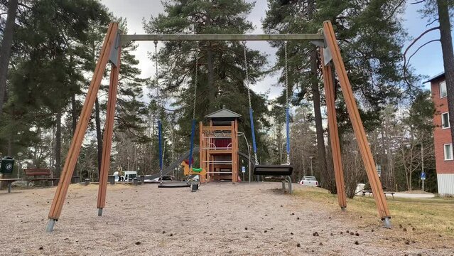 An empty playground with rocking swings