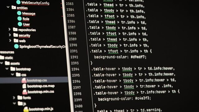 Software development in a special editor. On laptop screen code and application interface.