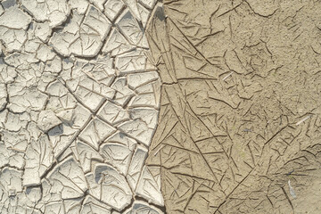 Dried and wet cracked silt soil, textured.