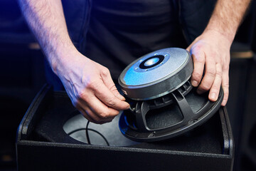 Worker is production speakers and loudspeakers at the factory. Handmade creation of acoustic music systems