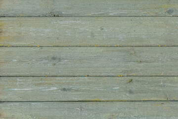 Naklejka premium Old wooden worn fence boards weathered texture in peeling green paint dirty obsolete background