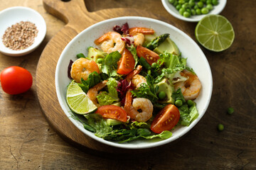 Healthy green salad with shrimps and avocado