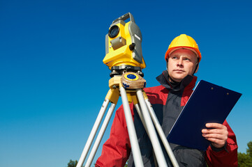 surveyor worker with theodolite over bright sky