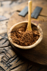 Organic cocoa powder in a wooden bowl