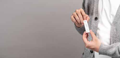 Close up of holding express antigen covid test, negative result