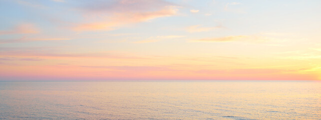 Baltic sea at sunset. Dramatic sky, blue and pink glowing clouds, soft golden sunlight, midnight...