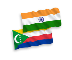 National vector fabric wave flags of India and Union of the Comoros isolated on white background. 1 to 2 proportion.