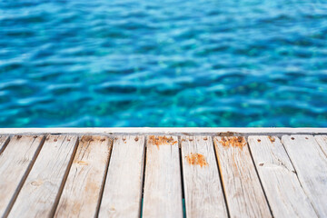 Empty wooden deck with the sea in the background.