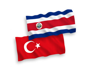 National vector fabric wave flags of Turkey and Republic of Costa Rica isolated on white background. 1 to 2 proportion.