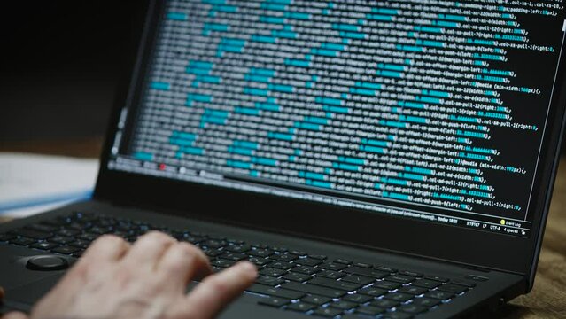 Programmer's hands and laptop keyboard close-up. Working on a project on a laptop.