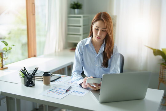 accountant, Auditor, Self-Employed, Finance and Investment, Marketing and Accounting, Portrait of Asian female entrepreneur using a calculator to calculate. Company business results document.
