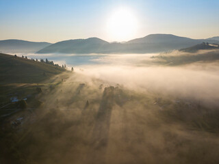 Obraz premium Morning fog in the Ukrainian Carpathians. Aerial drone view.