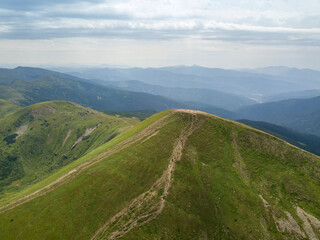 Naklejka premium High mountains of the Ukrainian Carpathians in cloudy weather. Aerial drone view.