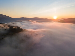 Obraz premium Sunrise over the fog in the Ukrainian Carpathians. Aerial drone view.