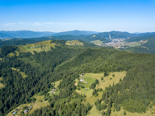 Fototapeta premium Green mountains of Ukrainian Carpathians in summer. Sunny clear day. Aerial drone view.