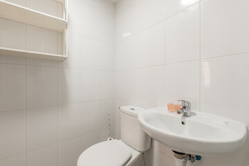 Bathroom with glass sliding door shower stall, porcelain hanging sink, integrated frameless mirror with light