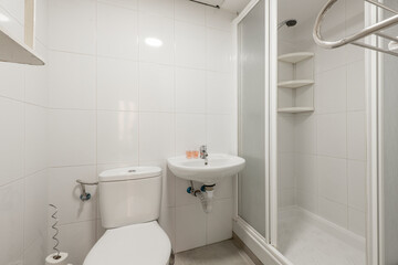 Bathroom with glass sliding door shower stall, porcelain hanging sink, integrated frameless mirror with light