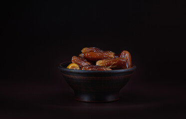 Clay cup full of ripe dried dates.