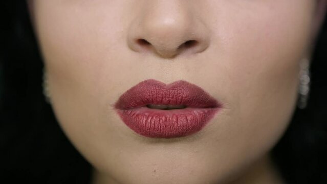 The girl makes an air kiss with her lips
