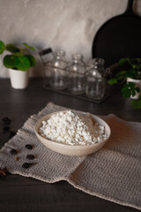 Ceramic dishes with a dairy product on a kitchen wooden table.