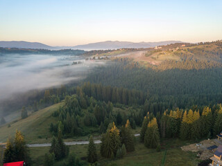 Morning mist in Ukrainian Carpathian mountains. Aerial drone view.