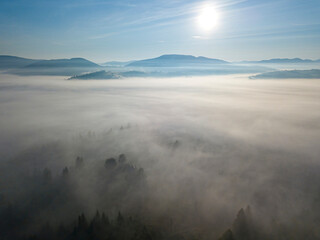 Morning mist in Ukrainian Carpathian mountains. Aerial drone view.