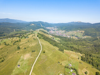 Green mountains of Ukrainian Carpathians in summer. Sunny clear day. Aerial drone view.