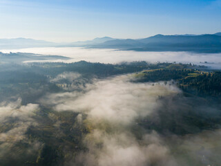 Morning mist in Ukrainian Carpathian mountains. Aerial drone view.