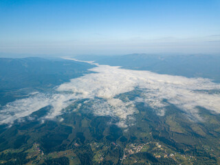 Fototapeta premium High flight in the mountains of the Ukrainian Carpathians. Fog in the valley. Aerial drone view.