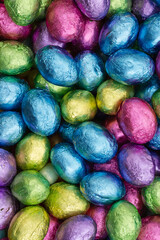 Colorful shiny Easter eggs candy background