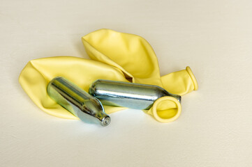 Pair of Nitrous oxide or laughing gas canisters and two balloons used for sniffing by addicts...