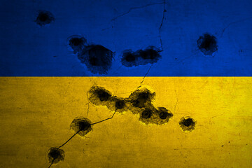Military conflict in Ukraine background. Flag with bullet holes and crack on concrete wall. Russian...