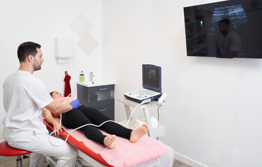 a physiotherapist performing an ultrasound scan for pelvic floor treatment