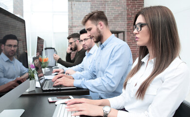 employees of the business center work on computers