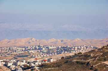 View of Judaean Desert and Maale Adumim town in haze from Mount Scopus in Jerusalem, Israel.