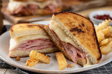 Grilled ham and cheese sandwich with french fries