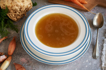 Homemade beef bone broth served in a white plate