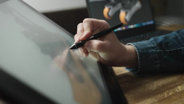 Experienced professional designer working on an interactive graphics tablet.